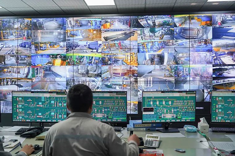 Engineers monitoring Distributed Control System screens