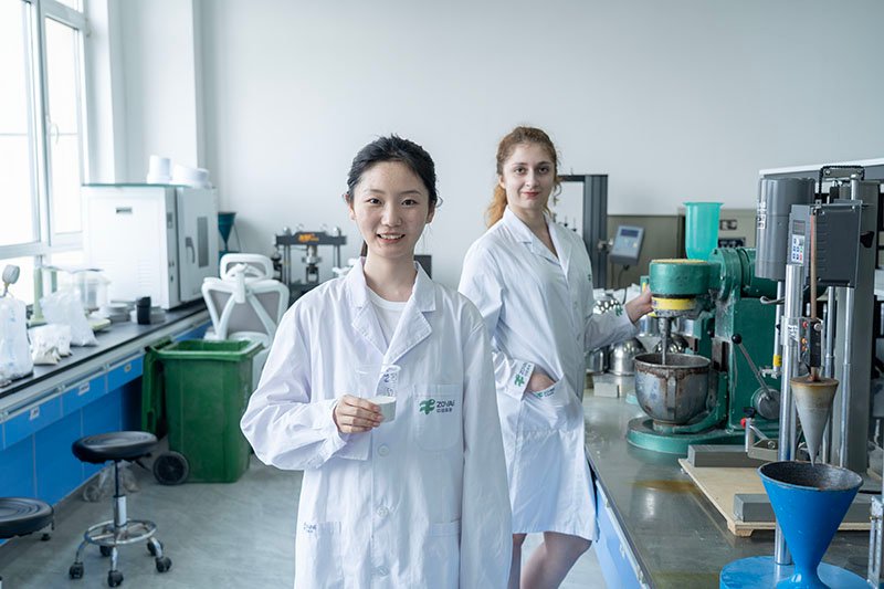 Engineers collaborating over chemical formulation plans