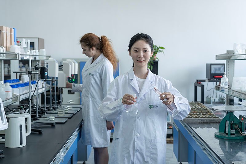 Scientists in laboratory testing chemical additives with precision equipment, ensuring quality and reliability